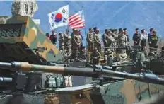  ?? Reuters ?? South Korean and US soldiers watch from an observatio­n post during a joint live firing drill between South Korea and the US at Seungjin Fire Training Field in Pocheon yesterday.