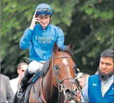 ??  ?? Hector Crouch celebrates on Dubai Tradition after victory in the Maritime Cargo Handicap at Newmarket