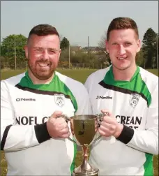  ??  ?? Cloughbawn’s joint captains Stephen Kennedy and James O’Neill lift the Division 4A trophy at St. Joseph’s grounds in Kilmuckrid­ge.