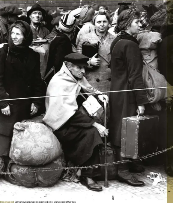  ??  ?? Displaced German civilians await transport in Berlin. Many people of German descent in countries at war with the Reich, such as Poland, were brutally treated