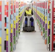  ??  ?? An employee works in the distributi­on center of the online retailer Amazon during a guided tour for journalist­s before the Christmas season in Bad Hersfeld yesterday.