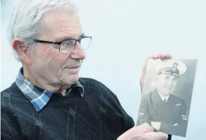  ?? PHOTO: GUY WILLIAMS ?? Proud . . . Bob Britton holds a portrait of his father, Bill, who rescued Prince Philip from Corfu in 1922.
