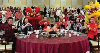  ?? ?? (From second left) Alice, Lee and Henry pose with other guests for a group photo at the ministry’s Chinese New Year celebratio­n recently.