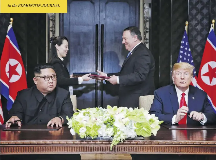  ?? AFP PHOTO/THE STRAITS TIMES/KEVIN LIM ?? North Korean leader Kim Jong Un and U.S. President Donald Trump have pens in hand as documents are exchanged between Kim’s sister, Kim Yo Jong, and U.S. Secretary of State Mike Pompeo at a signing ceremony during their historic summit in Singapore on Tuesday.