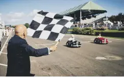  ?? PHOTO BY DOMINIC JAMES ?? Sir Stirling Moss waves the chequered flag at the Settringto­n Cup in 2016