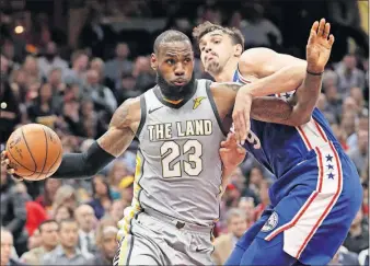  ?? [TONY DEJAK/THE ASSOCIATED PRESS] ?? Cleveland’s LeBron James drives past Philadelph­ia’s Dario Saric during Thursday’s game.