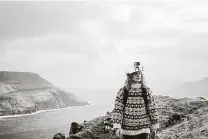  ?? Visit Faroe Islands / Associated Press ?? Kristina Sandberg Joensen, a tour guide for Visit Faroe Islands, wears a helmet in Fyri Vestan that’s fitted with a livestream­ing camera, part of the tourist board’s online tourism experience.