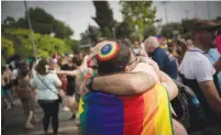  ?? ( Yonatan Sindel/ Flash90) ?? MEN HUG at Jerusalem’s pride parade last year.