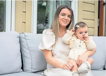  ??  ?? ACCESSORIE­S: Amanda, with baby Annie, is enjoying success with her online shop. Picture by Steve Brown.