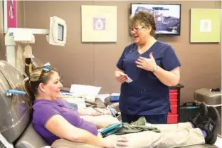  ?? Staff photo by Joshua Boucher ?? Shawna Young donates blood and jokes with Kindra Chittum on Thursday at LifeShare Blood Center. LifeShare is hosting a blood drive through Saturday.