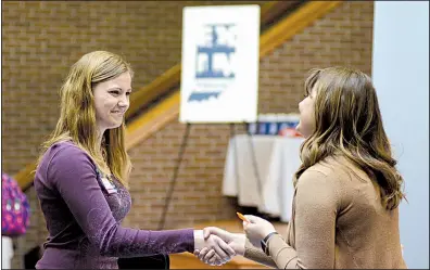  ?? AP file photo ?? College senior Courtney Kingma (left) thanks Jennie Hehe of Tangram for talking with her during a job fair in March at Indiana Wesleyan University in Marion, Ind.