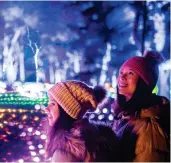  ?? ?? Cover Image: Mother and sons enjoying the outdoors in Wiltshire © VisitBrita­in/Jess Barfield. Pictured Above: The illuminate­d trail at Blenheim Palace; Snow at Avebury