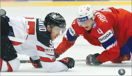  ?? Canadian Press photo ?? Canada’s Connor McDavid, left, challenges for the puck with Norway’s Johannes Johannesen, right, during the Ice Hockey World Championsh­ips group B match between Norway and Canada at the Jyske Bank Boxen arena in Herning, Denmark, Thursday.