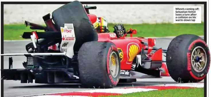  ??  ?? Wheels coming off: Sebastian Vettel loses a tyre after a collision on his warm-down lap