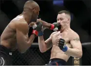  ?? JOHN LOCHER - THE ASSOCIATED PRESS ?? Kamaru Usman hits Colby Covington in a mixed martial arts welterweig­ht championsh­ip bout at UFC 245, Saturday, Dec. 14, 2019, in Las Vegas.