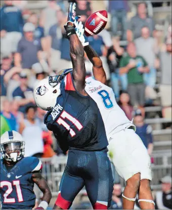  ?? STEPHEN DUNN/AP PHOTO ?? UConn linebacker Junior Joseph (11) rises on the final play of the game to break up a pass intended for Tulsa wide receiver Keenen Johnson (8) last Saturday, preserving the Huskies’ 20-14 victory.