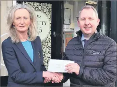  ?? ?? Mike Walsh of Walsh’s Pharmacy presenting lady captain Siobhan Feehan with sponsorshi­p for 2022.