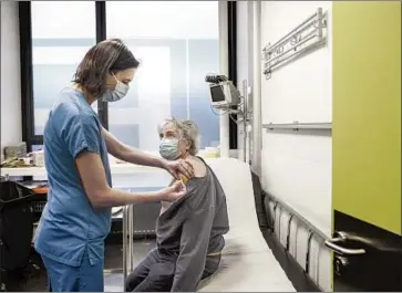  ?? Sameer al- Doumy AFP/ Getty I mages ?? A NURSE ADMINISTER­S a dose of the Pfizer- BioNTech COVID- 19 vaccine Saturday in Paris. In the f irst six days since the treatments were rolled out Dec. 27, just 516 of France’s 67 million people were vaccinated.