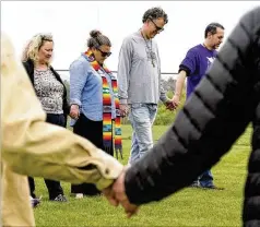  ?? MARK HUMPHREY/AP ?? A group of capital punishment protesters prays on the grounds of Riverbend Maximum Security Institutio­n before the scheduled execution of inmate Oscar Smith was called off in Nashville, Tenn., last month.