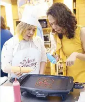  ??  ?? Creating pancake art is more fun when shared with family and friends. Author Kathy Moran and event host Monique Buensalido