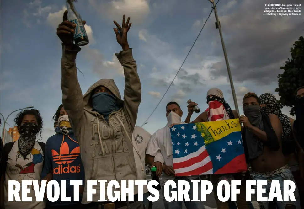  ??  ?? FLASHPOINT: Anti-government protesters in Venezuela — with unlit petrol bombs in their hands — blocking a highway in Caracas