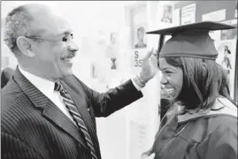  ?? Photos by Brian Harkin for USA TODAY ?? Counselor helps veterans: Eric Glaude helps Clover Mullings, a U.S. Army Reserve veteran and graduating student, with her cap at Borough of Manhattan Community College.