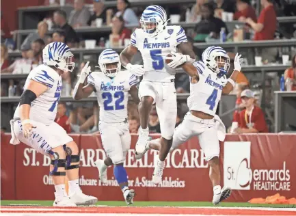  ?? JOE RONDONE/THE COMMERCIAL APPEAL ?? Memphis Tigerstigh­t end Sean Dykes celebrates his touchdown reception against the Arkansas State Red Wolves during their game at Centennial Bank Stadium in Jonesboro, Ark. On Sept. 11, 2021.