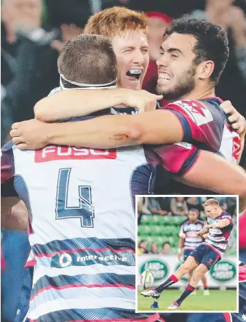  ??  ?? Nic Stirzaker celebrates with teammates after the Rebels stunned the Brumbies in Super Rugby action at AAMI Park last night. Inset: Reece Hodge kicks the winning penalty goal for the Rebels