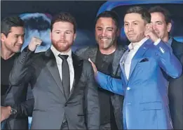  ?? Wally Skalij Los Angeles Times ?? CANELO ALVAREZ, second from left, and Gennady Golovkin are joined by Mario Lopez, Oscar De La Hoya and Tom Loeffler at L.A. Live.