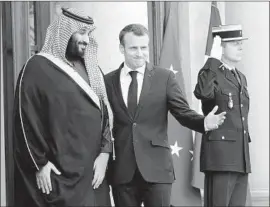  ?? Christophe Ena Associated Press ?? SAUDI CROWN PRINCE Mohammed bin Salman and French President Emmanuel Macron pause before their meeting at the Elysee Palace in Paris.