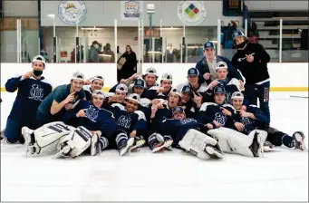  ?? Photos by Michelle Menard ?? The Burrillvil­le hockey team celebrated Sunday’s Burrillvil­le Spring Classic championsh­ip victory over Smithfield thanks to Ben Andersen’s (9, below) shot from, the top of the left circle in overtime.