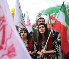  ?? AFP ?? Protesters with pre-1979 Revolution and People’s Mujahedin flags in Berlin supporting Iran’s Resistance Council