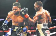  ?? JEFF ZELEVANSKY / GETTY IMAGES / AFP ?? Champion Terence Crawford nails Felix Diaz with a left hook during their WBO/WBC junior welterweig­ht title bout at Madison Square Garden on Saturday. Crawford improved to 31-0 when Diaz’s corner stopped the fight after the 10th round.