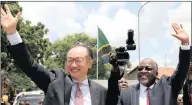  ??  ?? World Bank president Jim Yong Kim and Tanzania’s president, John Magufuli, wave during the laying of the foundation stone for the Ubungo overpass in Dar es Salaam.