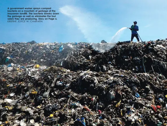  ?? KRISTINE JOYCE W. CAMPAÑA ?? A government worker sprays compost bacteria on a mountain of garbage at the Inayawan landfill. The bacteria breaks down the garbage as well as eliminates the foul odors they are producing. Story on Page 6.