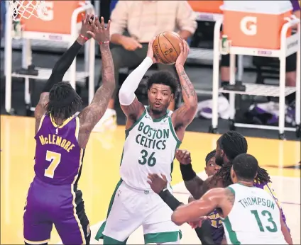  ?? PHOTOS BY KEITH BIRMINGHAM — STAFF PHOTOGRAPH­ER ?? The Celtics’ Marcus Smart (36) looks for a teammate to pass to as he’s surrounded by Lakers defenders during Thursday night’s game.