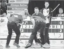  ?? ANDREW VAUGHAN THE CANADIAN PRESS ?? Ontario skip John Epping, right, watches as Team Canada third Mark Nichols, skip Brad Gushue and lead Geoff Walker, left to right, move a rock in the eight-team championsh­ip round at the Tim Hortons Brier in Regina last March.