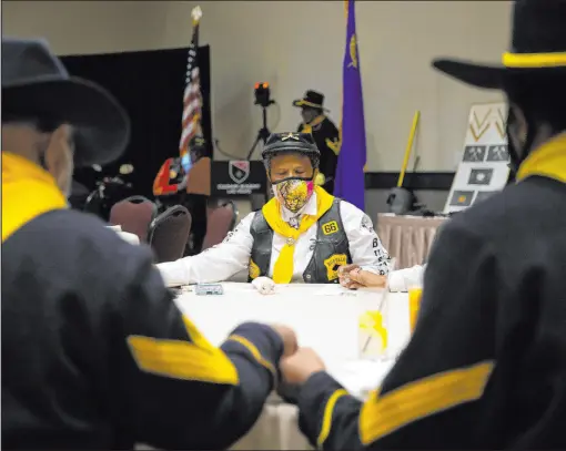 ?? Ellen Schmidt Las Vegas Review-Journal @ellenschmi­dttt ?? Dora Macklin, center, bows her head in prayer Saturday. The Southern Nevada Buffalo Soldiers 9th and 10th Horse Cavalry Associatio­n and the Buffalo Soldiers Motorcycle Club marked Buffalo Soldiers Day early.