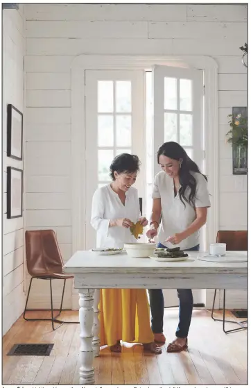  ?? (Amy Neunsinger via The New York Times) ?? Joanna Gaines
(right) and her mother, Nan, stuff grape leaves. Gaines’s mother left Korea when she was 19 to marry her father, Jerry, an American serviceman.