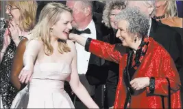  ?? Phil Mccarten ?? The Associated Press Elisabeth Moss, left, and author Margaret Atwood embrace as “The Handmaid’s Tale” wins the award for outstandin­g drama series Sunday at the 69th Primetime Emmy Awards at the Microsoft Theater in Los Angeles.