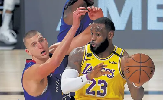  ?? Mike Ehrmann, Getty Images ?? Los Angeles guard LeBron James, right, passes against Denver center Nikola Jokic during the third quarter of Game 1 of the Western Conference Finals on Friday night in Lake Buena Vista, Fla.