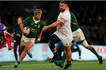  ?? — AFP file photo ?? South Africa’s wing Kurt-Lee Arendse (left) runs with the ball during the Autumn Nations Series Internatio­nal rugby union match between England and South Africa at Twickenham stadium, in London.