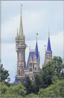  ?? JOHN RAOUX — THE ASSOCIATED PRESS ?? The top of the newly painted Cinderella Castle in the Magic Kingdom from World Drive at Walt Disney World on July 2 in Lake Buena Vista, Fla.