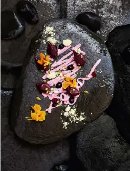  ??  ?? ABOVE A modern take on klepon, a palm-sugar dumpling, with beetroot and pumpkin seed, at Ubud’s speciality dessert eatery. OPPOSITE The Temple of the Elephant Cave, or Goa Gajah, was built in the 11th century. The pool is surrounded by five female figures clutching vases, which serve as water spouts.