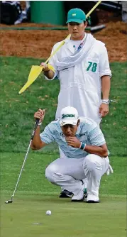  ??  ?? Hideki Matsuyama and his caddie, Shota Hayafuji, look over his birdie putt on the 16th hole, which he made to get to 10-under at the time.