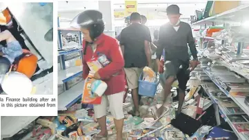  ?? — Reuters photo ?? Earthquake and tsunami victims looking for goods in a convenienc­e store in Palu.