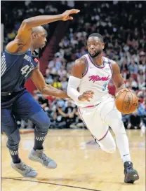  ?? AP PHOTO ?? Miami Heat guard Dwyane Wade (3) drives past Detroit Pistons forward Anthony Tolliver (43) during the second half of an NBA basketball game, Saturday in Miami.