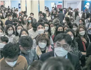  ?? WOOHAE CHO THE NEW YORK TIMES ?? Audience members leave after a showing of “The Phantom of the Opera” at the Blue Square culture complex in Seoul, South Korea, where its run has recently been extended.