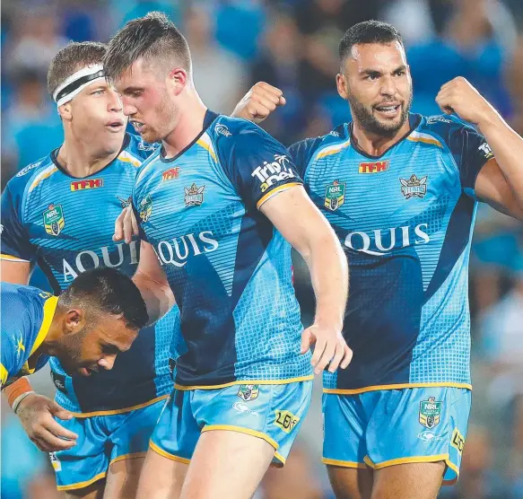  ?? Picture: GETTY IMAGES ?? Titans players celebrate a courageous Round 3 win over Parramatta at Cbus Super Stadium last night.