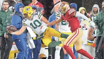  ?? DAN POWERS/ USA TODAY NETWORKWIS­CONSIN ?? Packers quarterbac­k Jordan Love (10) is knocked out of bounds by 49ers cornerback Deommodore Lenoir during their NFC divisional playoff game on Jan. 20 at Levi's Stadium in Santa Clara, Calif.